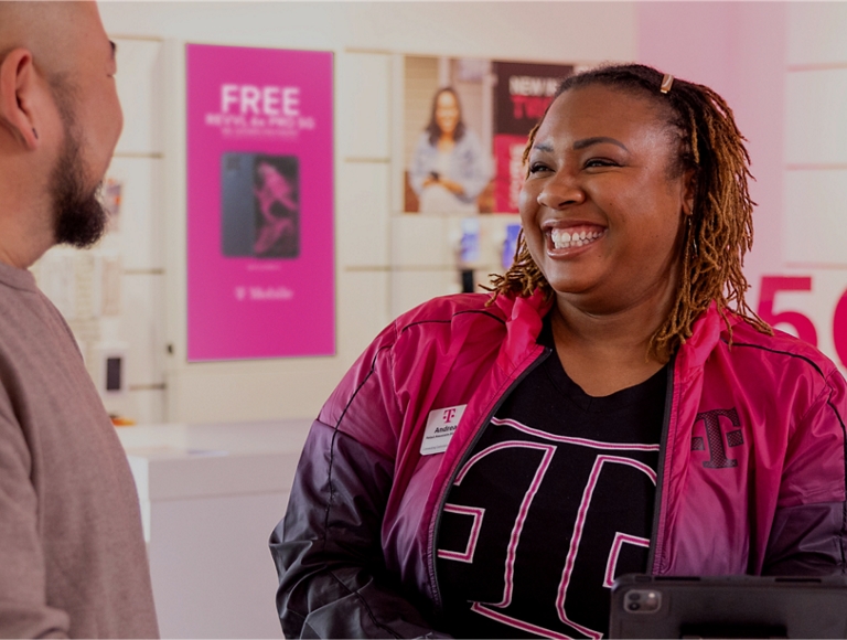 T-Mobile employee laughing with a customer